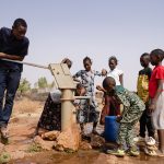african-school-age-children-gathering-around-a-sub-saharian-village-faucet-riccardo-mayer-shutterstock