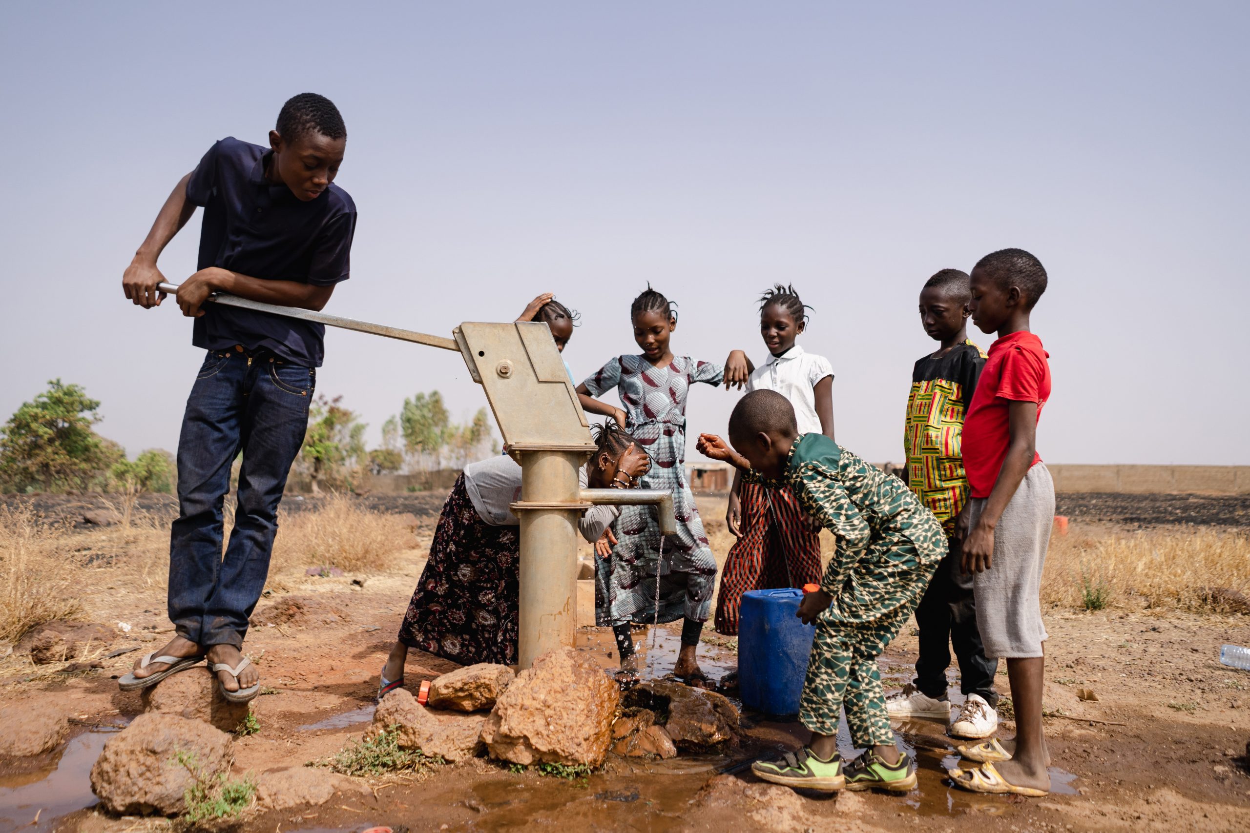 african-school-age-children-gathering-around-a-sub-saharian-village-faucet-riccardo-mayer-shutterstock